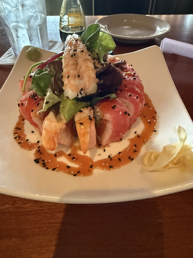 A plated sushi and seared tuna dish at a restaurant